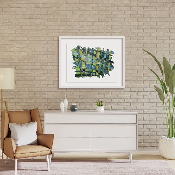 The artwork 'Feeling New' by Christina Massey features an abstract composition of interwoven green and blue brushstrokes and geometric patterns. Created using acrylic, linocut, and thread on canvas, the piece displays a dynamic weaving effect with textural elements. The artwork is elegantly displayed in a white frame against a neutral wall, showcasing its vibrant aquatic color palette. By Christina Massey.