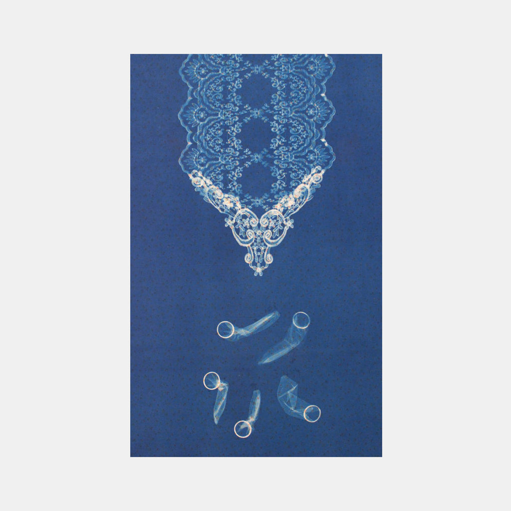 The artwork 'Five' by Warner Ball features a delicate cyanotype composition on fabric displaying an ornate lace-like pattern in luminous blue against a deep navy background. The upper portion shows intricate floral and scroll designs, while the lower section presents five abstract cylindrical forms arranged in a circular pattern, creating a harmonious balance of traditional and contemporary elements.