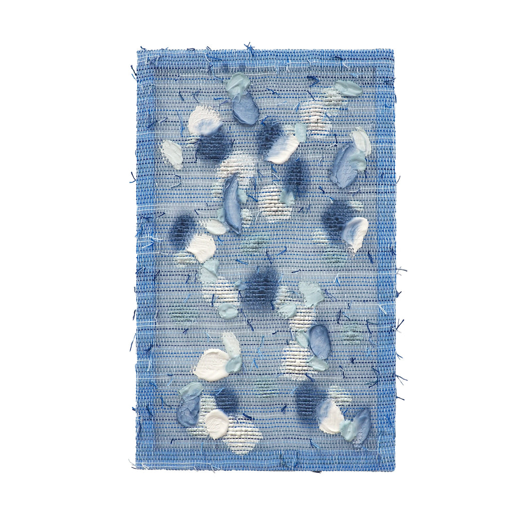 The artwork 'Frost' by Morgan Hale features a handwoven linen canvas adorned with abstract shapes in cool blue and white plaster. The textural composition creates a wintry landscape effect, with scattered irregular forms resembling ice crystals and snowflakes against a serene azure background. Dyed plaster elements add depth and dimension to the 11x18 inch piece.