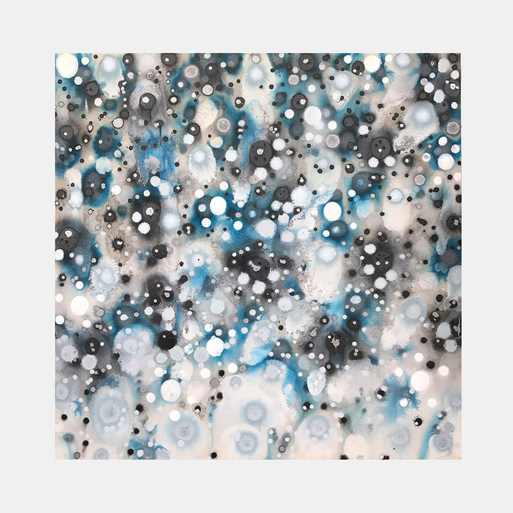 The artwork 'Glacial Galaxies' by Eric Jiaju Lee features an ethereal abstract composition with scattered circular forms resembling celestial bodies. Turquoise blue and charcoal grey spots float against a misty white background, creating a cosmic effect. The acrylic painting on canvas showcases overlapping circles and orbs with varying opacity, suggesting depth and movement. 46x46 inches by Eric Jiaju Lee.