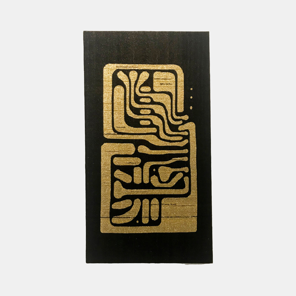 The artwork 'Harmonic Resonance' by Robin Kang features an abstract geometric pattern in metallic gold against a deep black background. The design resembles circuitry or ancient glyphs, with flowing curved lines and angular shapes woven together in Jacquard cotton. The composition creates a balanced vertical arrangement reminiscent of electronic pathways or mystical symbols.