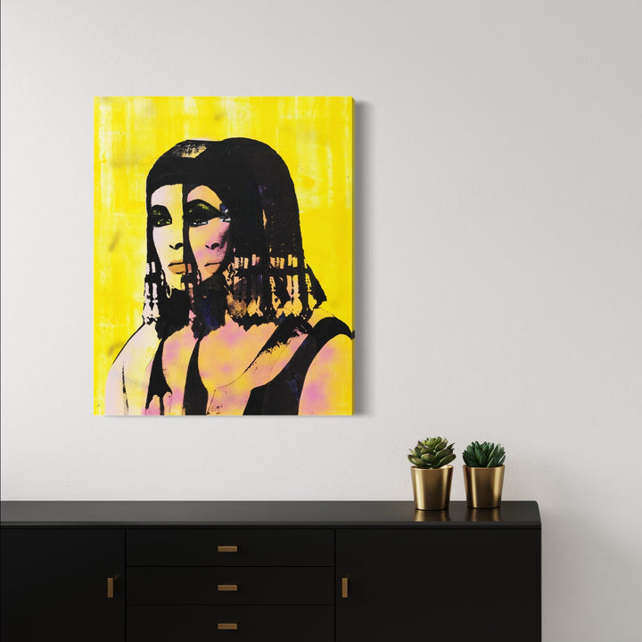 The artwork 'Seduction Is The Way [Cleopatra]' features a striking pop art-style portrait against a vibrant yellow background, incorporating silkscreen printing techniques with repeated overlapping imagery. The composition shows a stylized figure rendered in pink and black tones, creating a bold contrast against the bright yellow canvas. Mixed media artwork combining silkscreen, spray paint, and acrylic by Rudy Meyer.