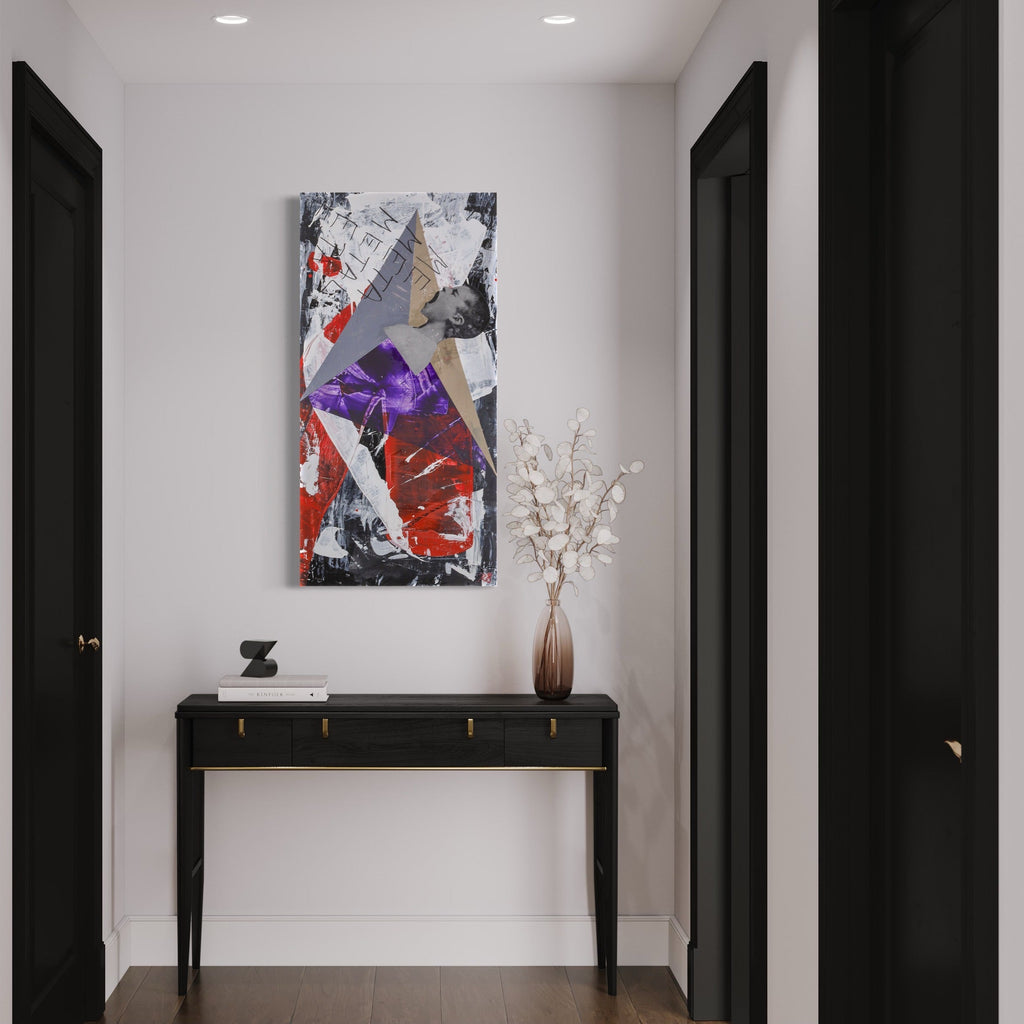 The artwork 'The Obelisk of Babbleon' by Roger Hsia features a striking mixed media collage with bold geometric shapes in purple, red, and gray tones. Abstract triangular forms intersect against a textured background of torn paper and paint, creating dynamic movement and depth. The vertical composition measures 48x24 inches and hangs elegantly above a contemporary console table.