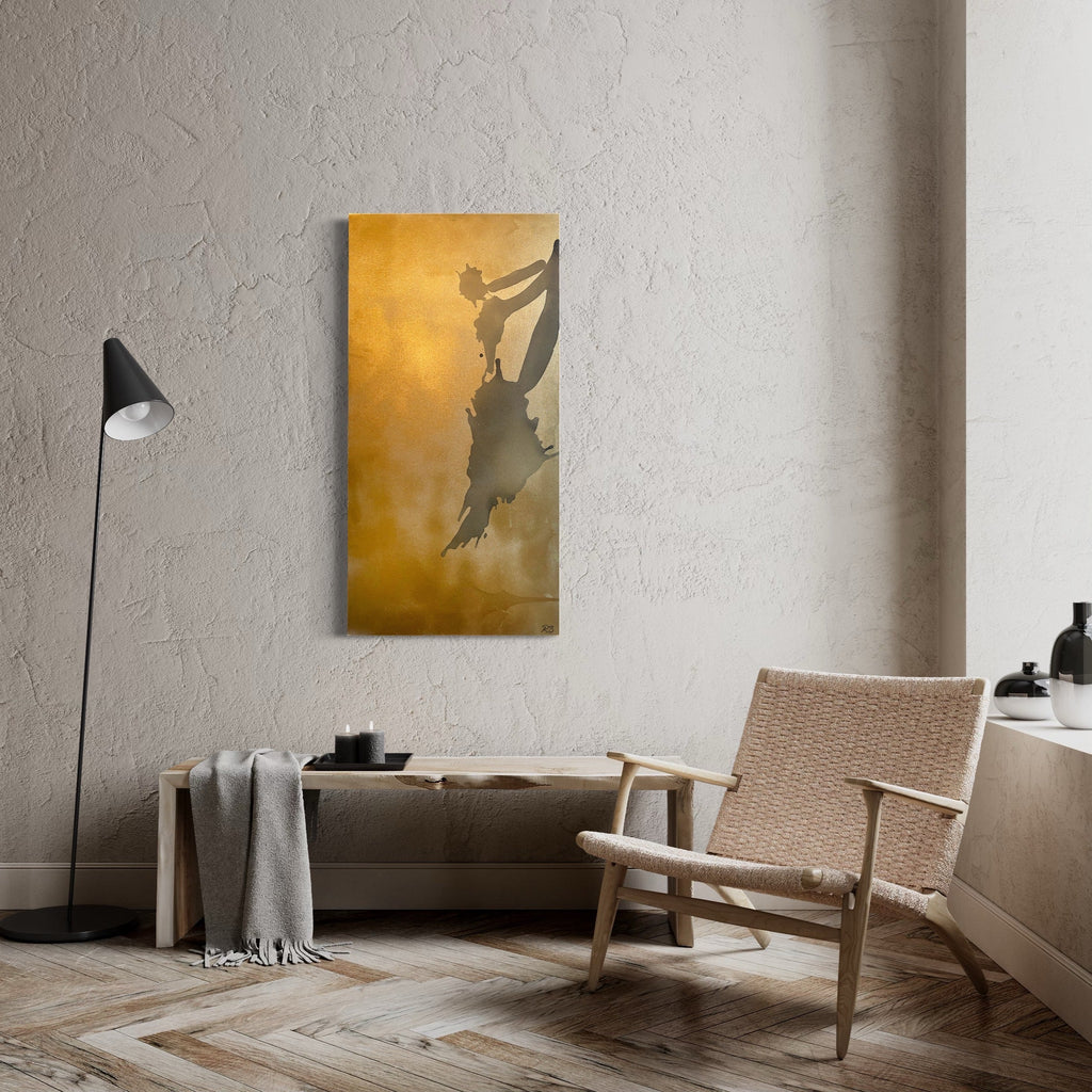The artwork 'The Art of Unlearning' by Roger Hsia features a dramatic silhouette against a luminous golden background. The abstract form appears to be floating or leaping, creating a sense of movement and freedom. The acrylic painting employs a minimalist style with rich amber tones and shadowy contrasts on a 48x24 inch canvas by Roger Hsia.