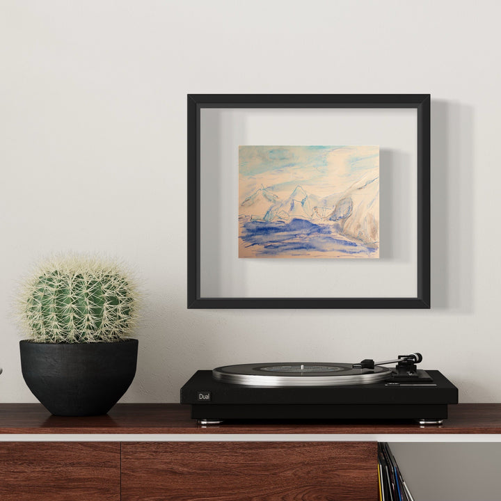 The artwork 'Dorian Bay' by Ali Ha features a serene abstract seascape rendered in soft blue and peach watercolors on warm white Stonehenge paper. Delicate ink lines suggest mountainous forms rising from tranquil waters, creating a minimalist coastal scene. Displayed in a sleek black frame, the piece conveys a peaceful, ethereal atmosphere through its gentle color palette and fluid brushwork.