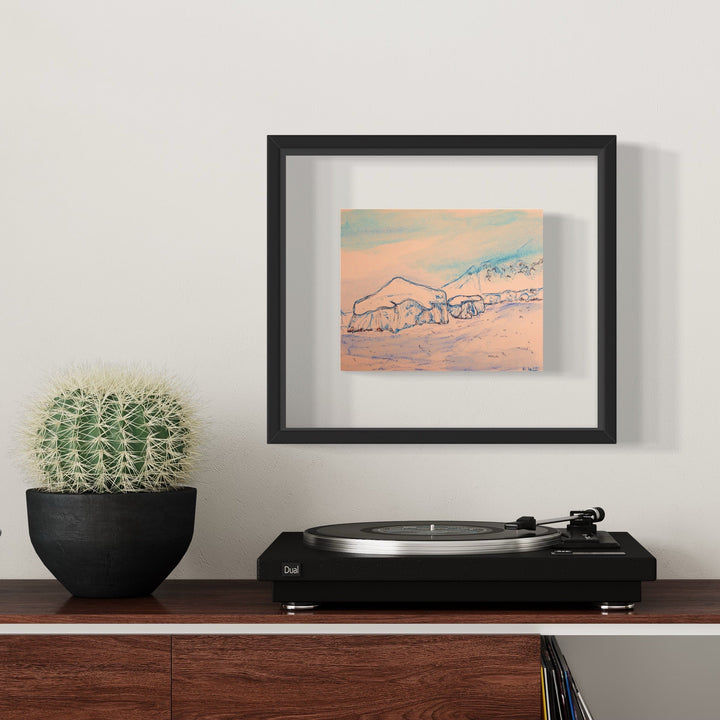 The artwork 'Half Moon Island' by Ali Ha features delicate ink line drawings depicting a mountainous coastal landscape in soft peach and turquoise tones on warm white Stonehenge paper. The minimalist sketch captures rolling hills and water's edge, elegantly framed in black. Professional archival ink and Caran d'Ache medium create subtle texture and depth. By Ali Ha.