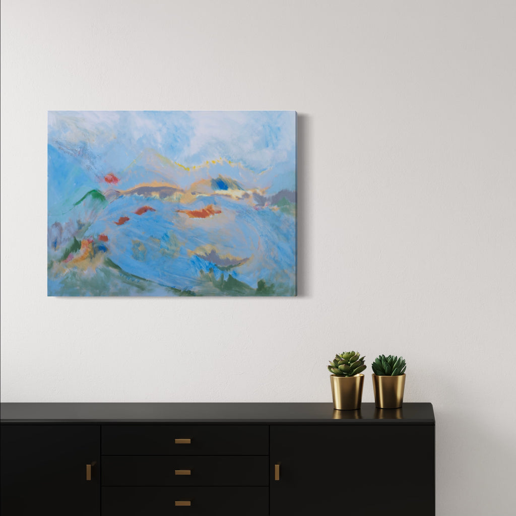 The artwork 'Gestural Landscape' by Beth Barry features sweeping brushstrokes in vibrant blues, with accents of coral red and sandy beige. Abstract mountainous forms emerge through dynamic, fluid brushwork, creating a dreamy atmospheric scene. Loose, expressive strokes in green anchor the bottom, while soft white clouds drift above in this 30x40 inch acrylic painting. By Beth Barry.