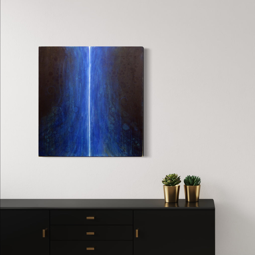 The artwork 'Message 1' by Sonomi Kobayashi features a striking vertical beam of bright electric blue light cutting through a dark background, creating a dramatic contrast. The oil painting exhibits ethereal qualities with subtle gradients from deep navy to brilliant azure, with textural brushstrokes adding depth and movement across the 36x34 inch canvas.