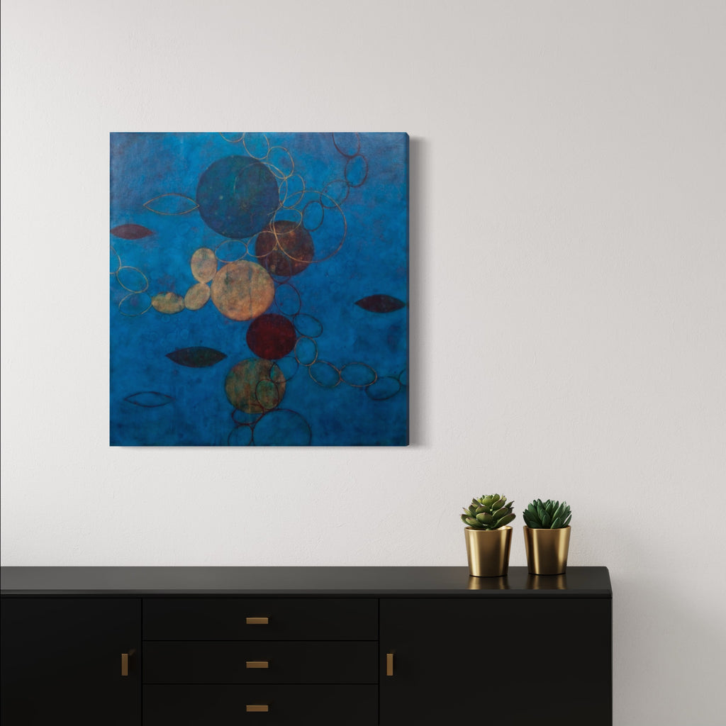 The artwork 'Synchronicity' by Sonomi Kobayashi features floating circular forms against a deep azure background. Abstract spheres in earthy browns, golds, and muted greens interconnect through delicate linear patterns. Oil on linen creates rich textural depth, while organic leaf-like shapes add natural elements to this contemporary abstract composition.
