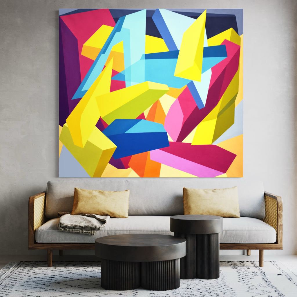 Meta of the Beta by Kati Vilim features vibrant geometric abstraction with dynamic angular shapes in bold yellow, bright pink, light blue, and deep purple. The large-scale oil painting on canvas showcases sharp intersecting forms creating a sense of movement and depth through overlapping geometric elements against a gray background. 66x72 inches abstract artwork.