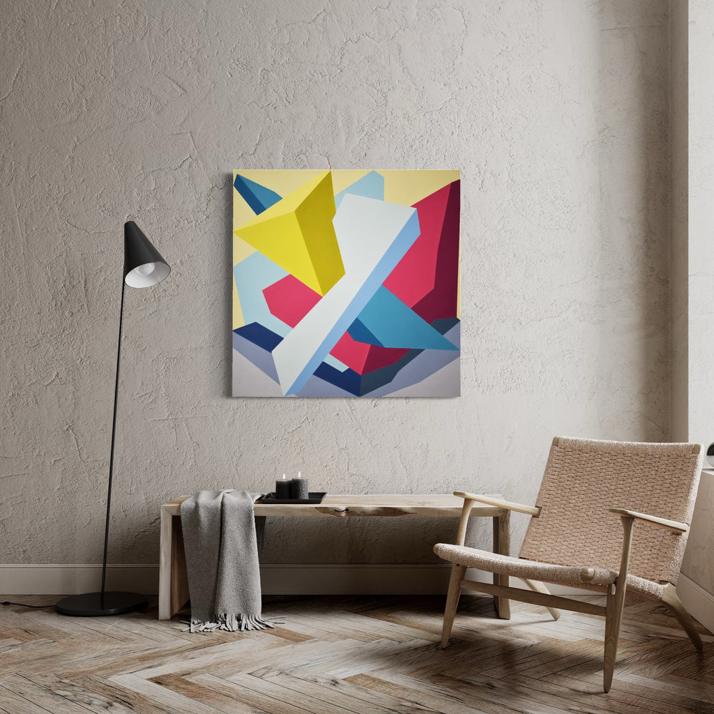 The artwork 'Nothing Personal' by Kati Vilim features bold geometric abstract shapes in vibrant colors including yellow, pink, turquoise, and navy blue on a white background. Angular forms intersect and overlap creating dynamic composition with sharp edges and clean lines in minimalist style. Oil on canvas over panel displayed in modern interior setting.