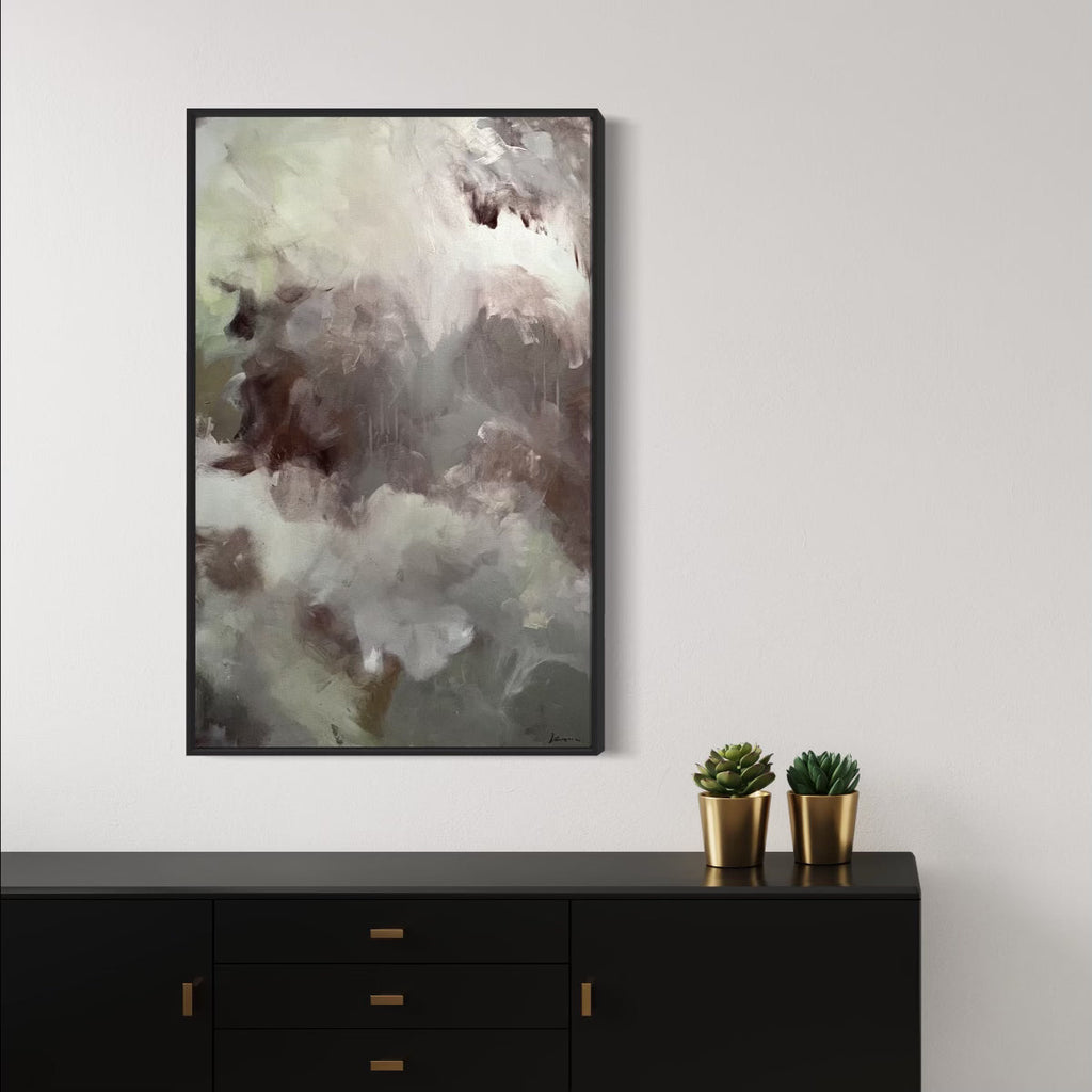 The artwork 'Chocolate' by Kyria Fortina features ethereal swirls of rich brown and creamy white tones, creating a dreamy abstract composition. Textured brushstrokes in acrylic paint blend seamlessly on stretched canvas, evoking the essence of melting chocolate against a misty background, framed in sleek black. 48x30 inches.