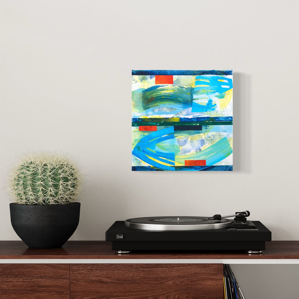 The artwork 'Cyclops' by Lisa Petker Mintz features abstract expressionist brushstrokes in vibrant turquoise blue and yellow, divided by horizontal navy bands. Red geometric accents punctuate the composition, creating dynamic movement across the 12x12 inch mixed media board. The piece combines fluid, aquatic-like swirls with structured geometric elements in a contemporary style by Lisa Petker Mintz.