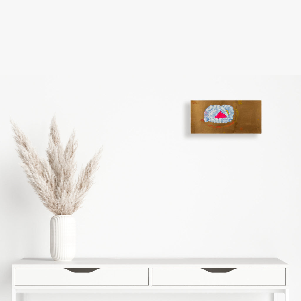 The artwork 'Pop Tube' by Songyi Kim features a whimsical accordion-like tube structure in light blue and white, coiled around a vibrant pink triangular shape on a warm brown background. The piece combines acrylic paint's bold strokes with delicate colored pencil details, creating a playful contrast of textures and dimensions on paper.