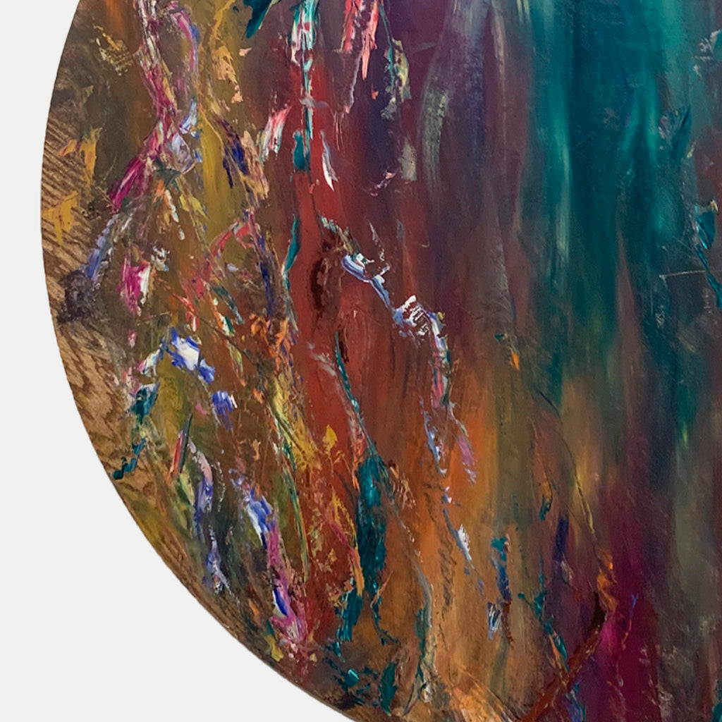 The artwork 'Impressions of Light 3' by Jadie Meprivert features a circular abstract composition with vibrant fluid strokes of teal, burgundy, gold, and coral. The oil on wood painting showcases dynamic vertical movements with rich textural elements, creating a dramatic interplay of light and shadow across its 48-inch diameter surface.