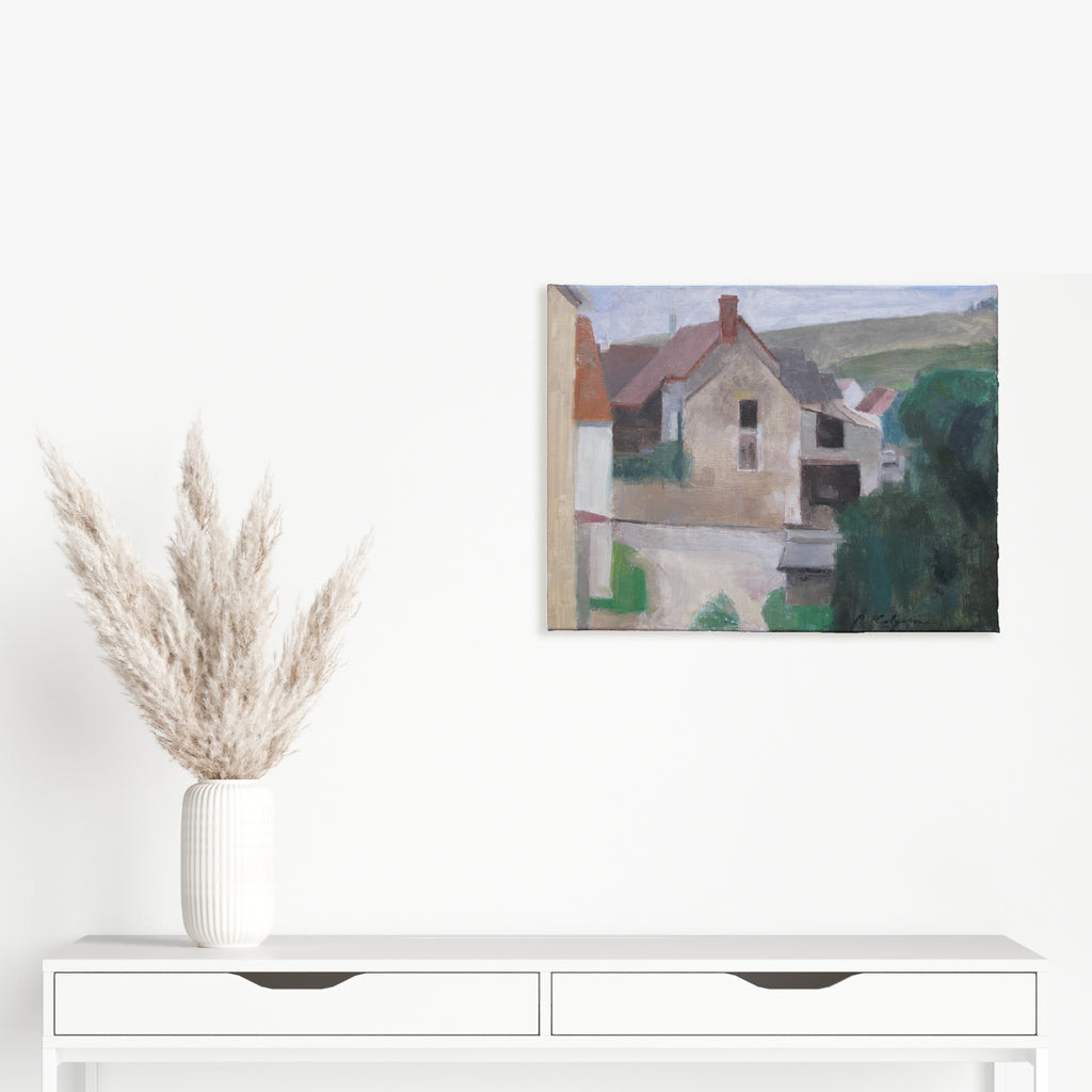The artwork 'Irancy Farm House' by Peter Colquhoun depicts a rustic French countryside scene with a stone farmhouse featuring a red-tiled roof. The composition uses muted earth tones, soft greens, and subtle grays to capture the pastoral setting. Rolling hills form the background while gentle brushstrokes create a serene, impressionistic atmosphere. Oil on linen, 17x22 inches by Peter Colquhoun.
