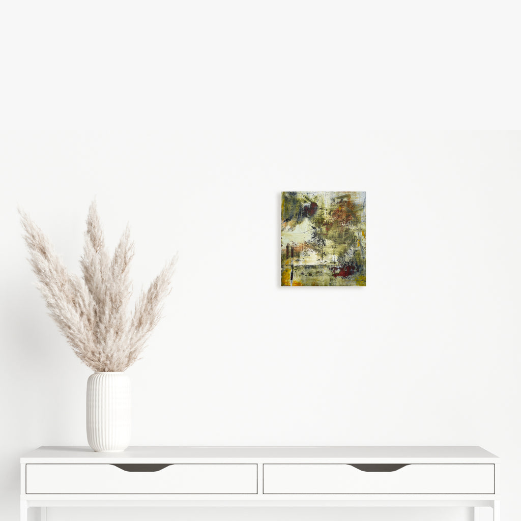 The artwork 'LEXINGTON AV' by Barbara Groh features abstract layers of olive green and earthy tones blended with textural elements. The mixed media piece combines oil paint and cold wax on clay paper, creating a weathered, organic appearance with subtle geometric forms emerging from the distressed surface. The composition suggests an urban landscape viewed through an ethereal lens.
