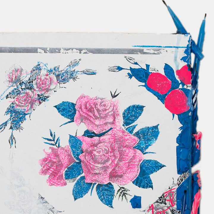 The artwork 'Letter iii' by Troy Medinis features vibrant pink roses with electric blue leaves created through gesso transfer technique. The composition shows a delicate floral pattern against a white background, with textural elements achieved through molding paste and spray paint. Birthday candles add dimensional detail to this mixed media piece measuring 11.5 x 9 inches. By Troy Medinis