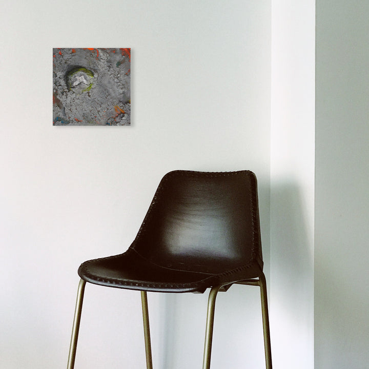 The artwork 'Maine Tidal Stone' by Barbara Groh features abstract swirls of textured gray and charcoal tones with striking accents of lime green and orange. The mixed media piece combines ocean earth and acrylic on hardboard, creating a dynamic coastal-inspired composition with an organic, weathered appearance reminiscent of tidal patterns and geological formations.