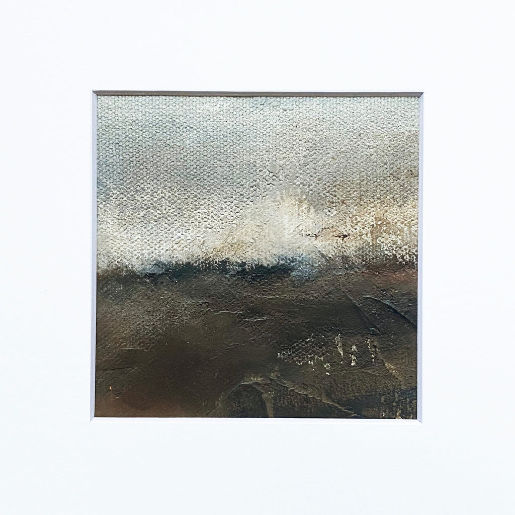 The artwork 'MOMENTUM II' by Xanthippe Tsalimi features an abstract landscape with a dramatic contrast between a luminous silvery-white sky and a dark earthen ground. The oil painting showcases a textured horizon line where light and shadow meet, creating a moody atmospheric effect through layered brushstrokes on canvas.