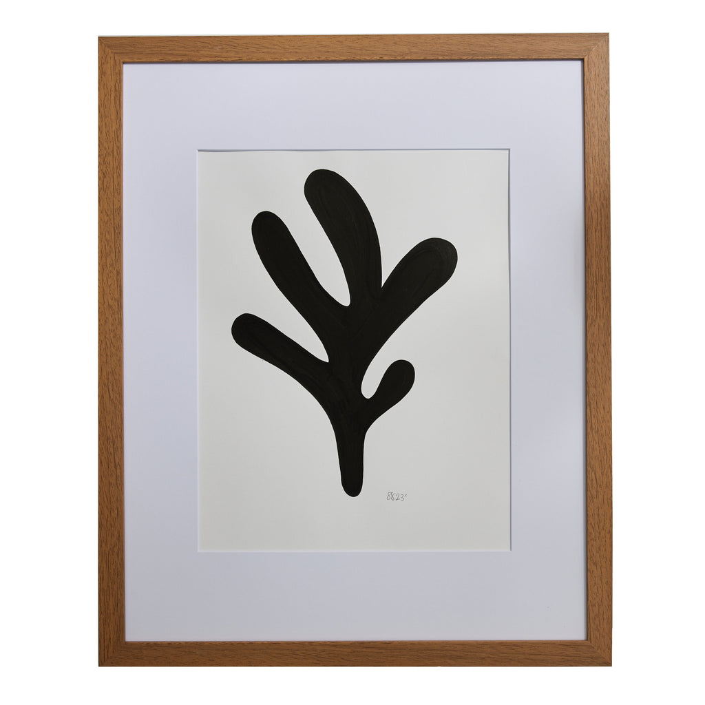 The artwork 'Morning Meditation V' by Shadia Sabagh features a bold black organic shape against a white background, reminiscent of a Matisse-inspired leaf or branching form. The minimalist composition, created with acrylic marker on mixed media paper, is elegantly framed in wood with a white mat, measuring 20x16 inches. By Shadia Sabagh.