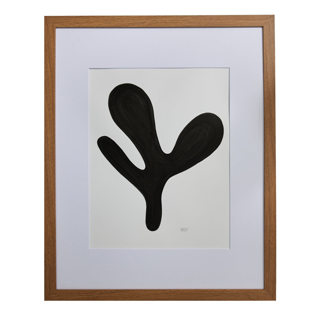 The artwork 'Morning Meditation X' by Shadia Sabagh features a bold black organic shape against a white background, resembling a minimalist abstract plant form. The artwork, created with acrylic marker on mixed media paper, is elegantly presented in a wooden frame with white matting, measuring 20x16 inches.