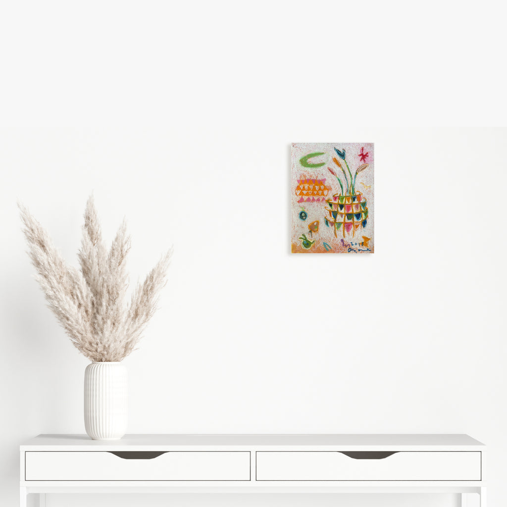 The artwork 'Magic Flute' by Ayane Kurai features whimsical abstract floral elements in vibrant watercolors and cray-pas. Green stems curve gracefully upward, supporting delicate pink blooms against a soft gray background. Geometric patterns and colorful dots create a playful, textured composition on the 12x9 inch paper.