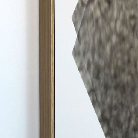 The artwork 'May Save Teeth' by Evan Ishmael features an abstract geometric composition created with soot on panel. The piece showcases a sharp angular form in mottled grey tones against a stark white background, creating a dramatic contrast. A subtle bronze-toned vertical element adds depth to the 24x18 inch contemporary work.