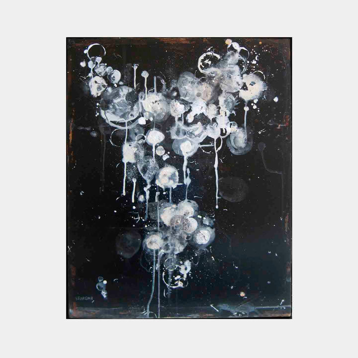 The artwork 'Midnight One' by Shira Toren features ethereal white and gray circular forms floating against a deep black background. Abstract drips and splatters create a celestial effect, with translucent orbs cascading downward like cosmic bubbles. Painted in acrylic on canvas, the piece combines fluid techniques with controlled dripping effects, measuring 30x24 inches.