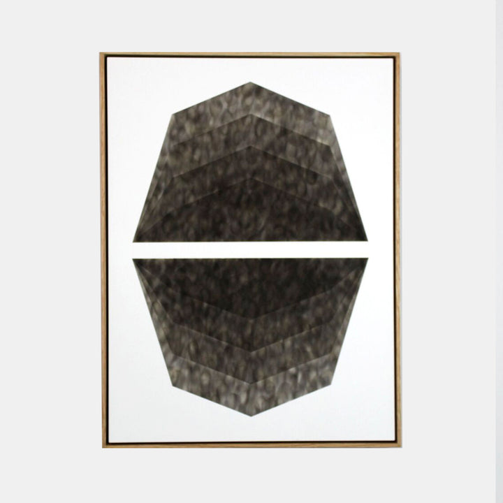 The artwork 'Mild Climate Needed' by Evan Ishmael features a striking geometric composition of split octagonal shapes rendered in rich charcoal soot on panel. The textured, smoky surface creates a dynamic contrast against white background, showcasing layered depths and angular patterns within a minimalist design. 24x18 inches. By Evan Ishmael.