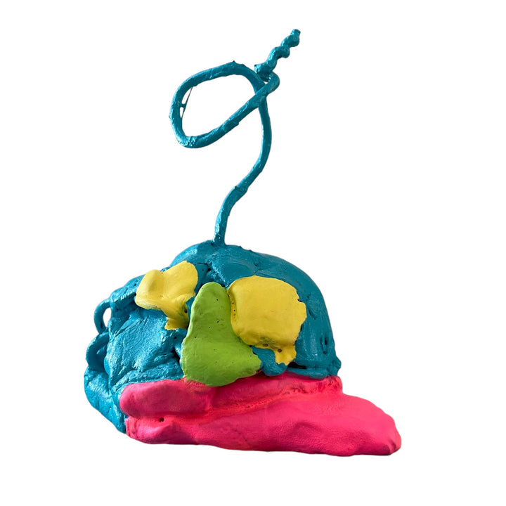 The artwork 'Mind Melting, Away' by Brandon Hodges features a sculptural piece with vibrant turquoise, yellow, lime green, and hot pink colors in apoxie sculpt. A curved wire emerges from the top, creating a whimsical spiral shape while the base appears to melt and drip, showcasing a dynamic interplay of textures and organic forms.