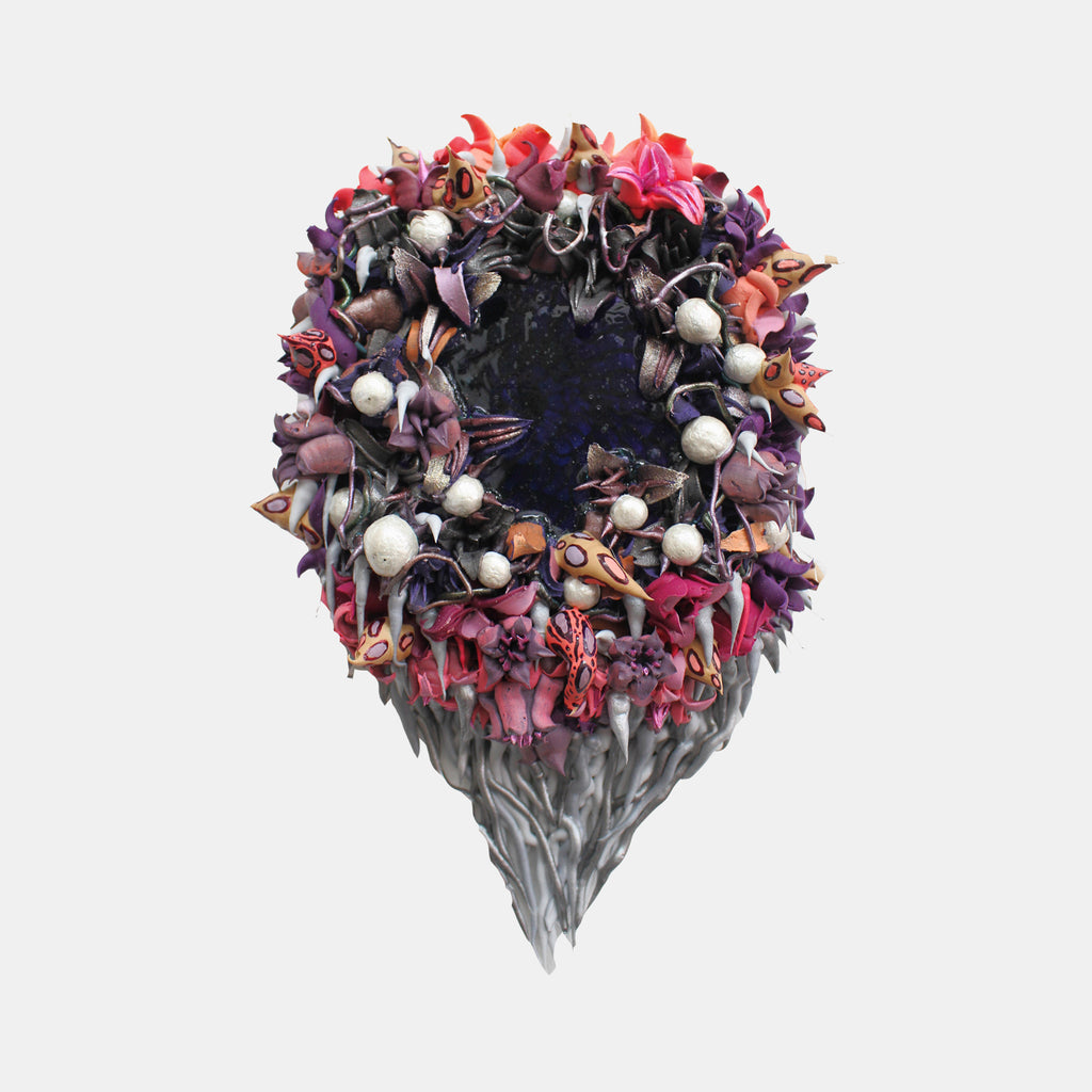 The artwork 'Mirroire' by Seren Morey features a circular wreath-like formation of intricate sculptural elements in vibrant coral, purple, and mauve tones, adorned with pearlescent white spheres. The textured composition, created with ultralight acrylic and urethane, emerges from a dark center and cascades downward in a dramatic tear-drop shape with flowing gray tendrils.