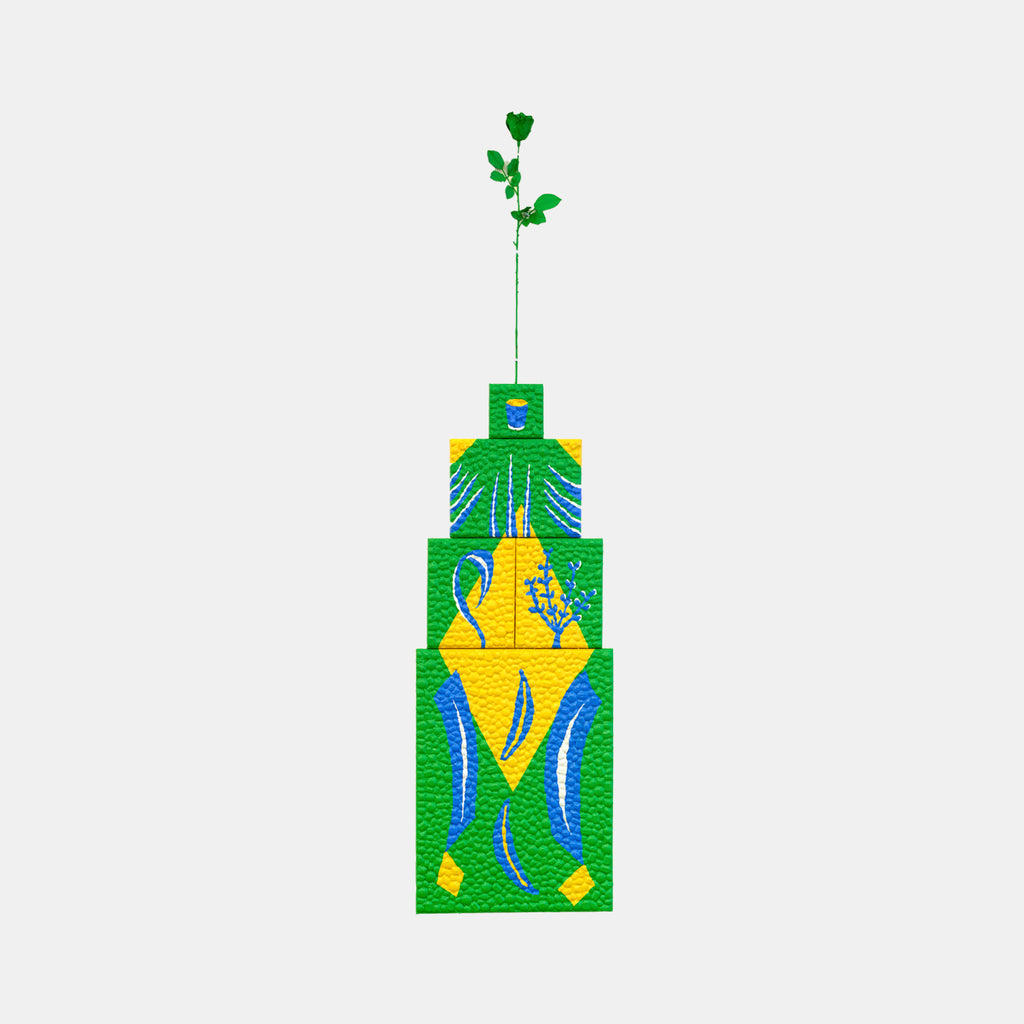The artwork 'Neither Here Nor There E' by Marco DaSilva features a vertical geometric composition with a tiered green structure adorned with vibrant yellow accents and flowing blue curves. A delicate green stem with leaves extends from the top, embellished with rhinestones and finished in glossy polyurethane on canvas.