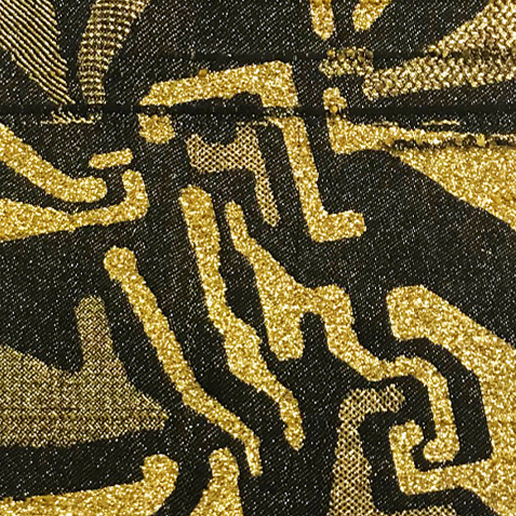 The artwork 'Noise Gate' by Robin Kang features intricate geometric patterns woven in metallic gold yarn against a deep black cotton background. Abstract angular shapes and curves create a dynamic composition reminiscent of circuit boards or digital patterns. Hand jacquard weaving technique adds rich texture and dimensional contrast between matte cotton and shimmering metallic elements.