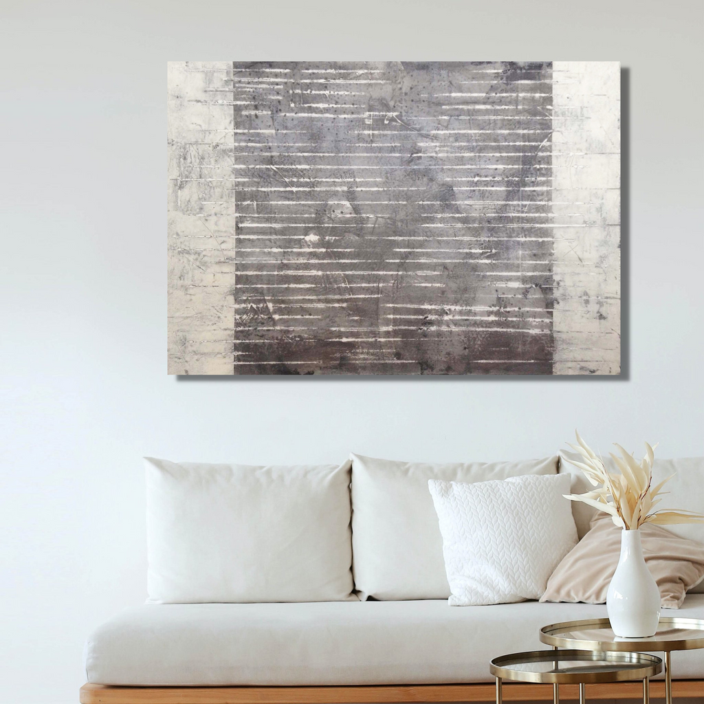 The artwork 'Opposite Wall' by Shira Toren features horizontal striations in contrasting shades of silver and charcoal grey, created with Venetian plaster on canvas. The composition is divided by a stark vertical line, with textured metallic tones on one side and deeper, shadowy hues on the other, showcasing a minimalist abstract aesthetic.