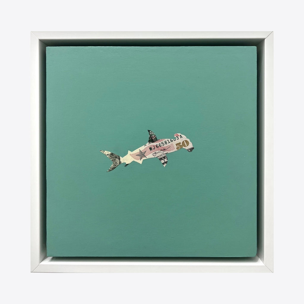 Spirit Messengers, Hammerhead by Jacki Davis features a minimalist composition on a seafoam green background. A small hammerhead shark silhouette is crafted from collaged US currency, creating intricate detail within the shark's form. The artwork is presented on an 8x8 inch wood panel with acrylic medium, framed in white.