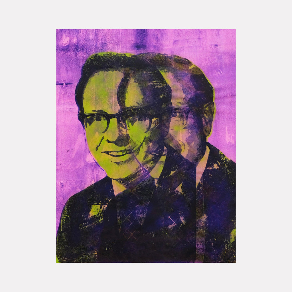 The artwork 'Capitalism Is The Way' features a portrait rendered in vibrant pop art style against a striking magenta background. The silkscreen print shows a figure wearing glasses, executed in bold yellow and deep purple tones with layered spray paint effects creating a dynamic, multi-dimensional appearance on canvas. Created by Rudy Meyer.