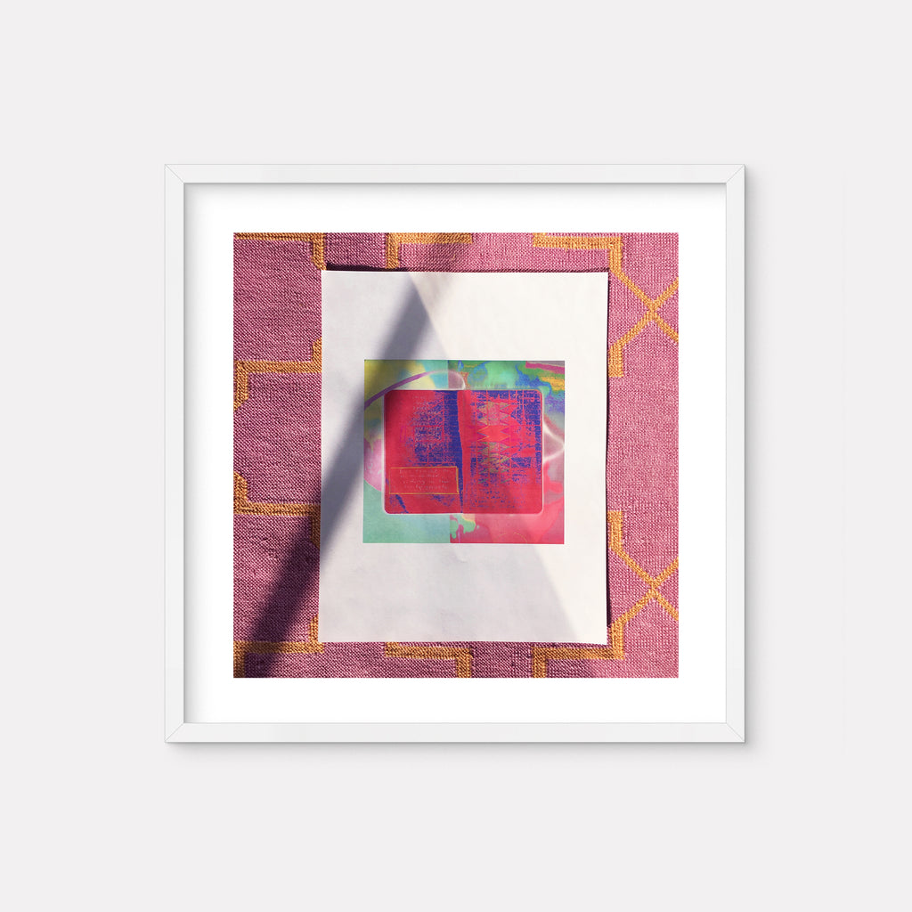 The artwork 'Rolling in the Dusty Streets' by Anne Sherwood Pundyk features a vibrant abstract composition framed in white. A central square in deep magenta is set against a turquoise background, creating dynamic contrast. The piece showcases geometric shapes with textural elements, presented in a modern digital print style with a pink-toned border and subtle golden linear patterns.