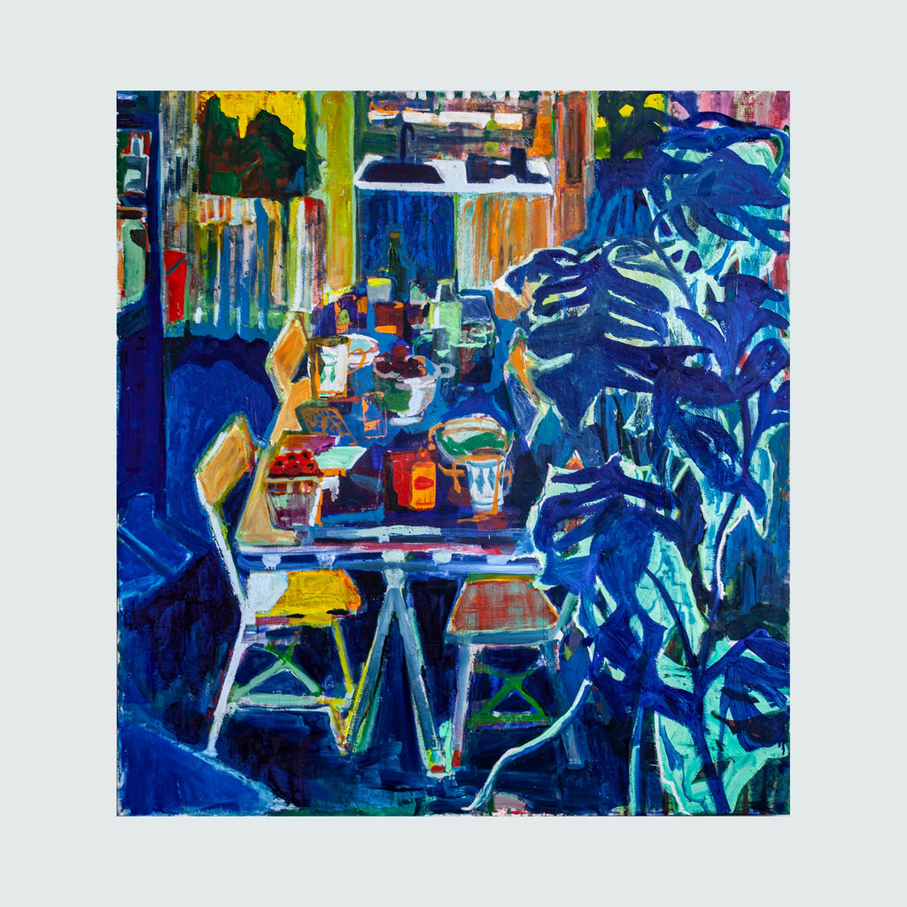 The artwork 'Kitchen Blues' by Allison Gildersleeve features a vibrant abstract kitchen scene rendered in bold blues, yellows, and greens. A table with chairs stands centrally, surrounded by kitchen items and shelving. The expressive brushstrokes create a dynamic, energetic composition, with lush botanical elements in deep blue tones dominating the right side. The oil and acrylic painting merges modern abstraction with domestic imagery.