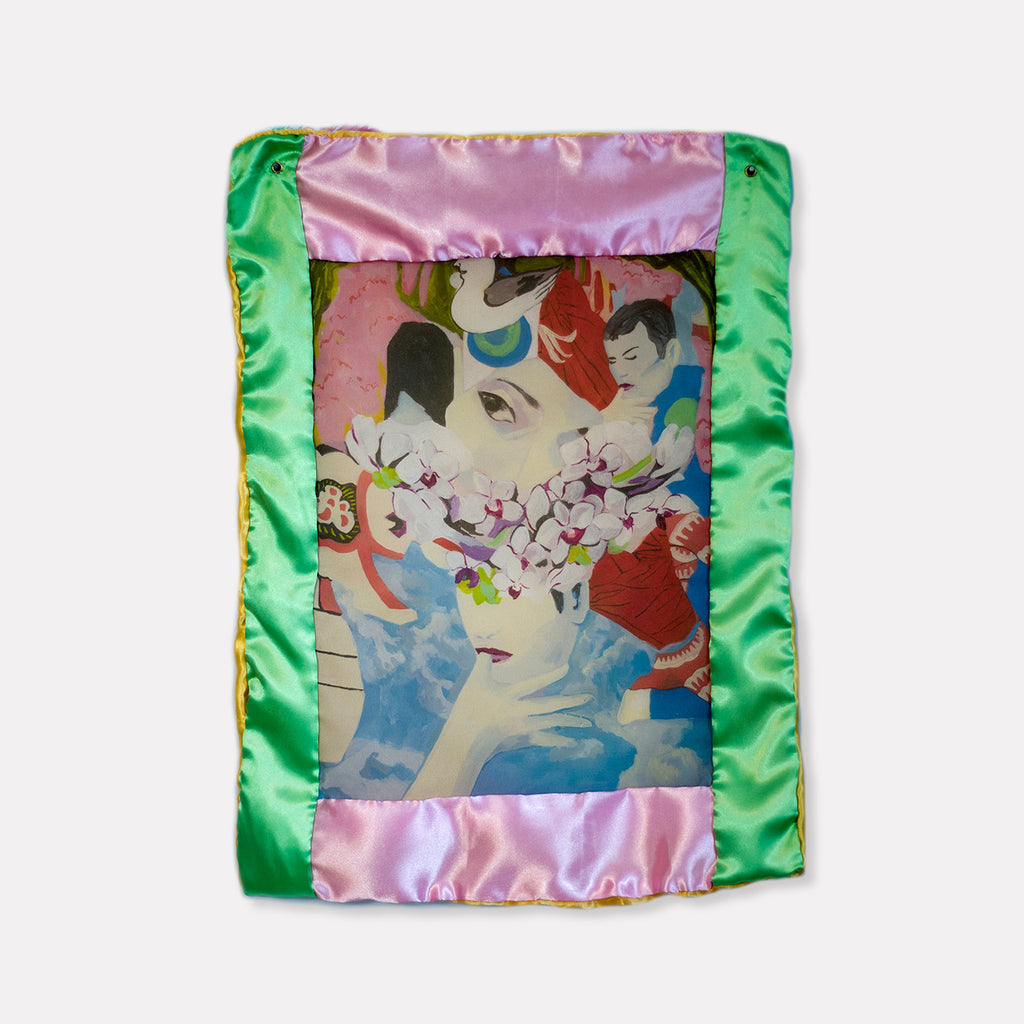 The artwork 'Orchid Eye Mini Quilt' by Eriko Hattori features a dreamy illustration framed by vibrant emerald green and rose pink satin borders. The central image showcases an ethereal composition with cherry blossoms, rendered in soft pastels and bold colors on polyester georgette fabric, secured with metallic grommets. The 12x15 inch textile artwork combines Asian-inspired motifs with contemporary design elements.