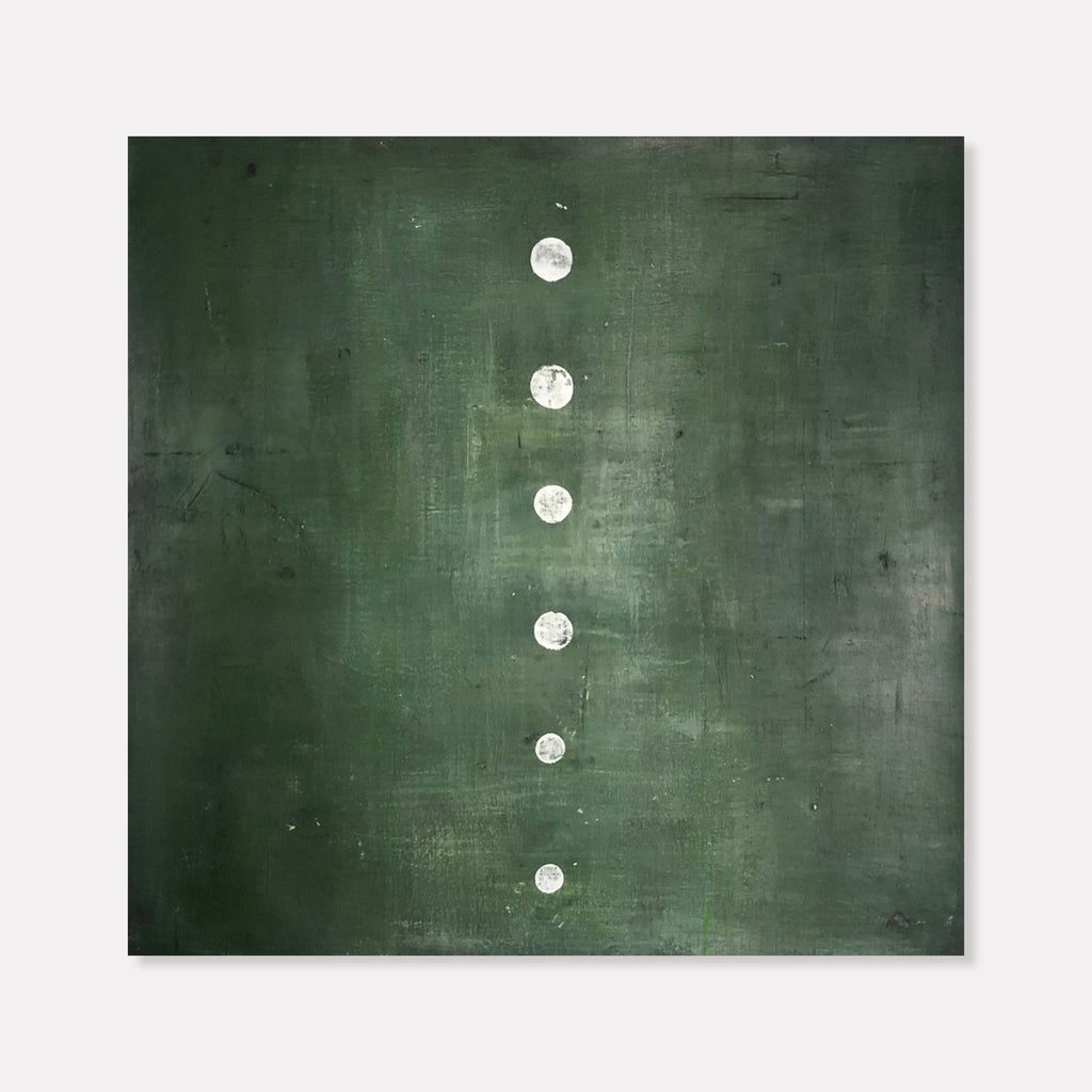 The artwork 'Green Stone' by Shira Toren features a minimalist composition with six white circular forms arranged vertically against a deep forest green background. The textured Venetian plaster surface creates subtle variations in the emerald tones, while the luminous white circles appear like ascending moons or stepping stones against the moody, atmospheric canvas.