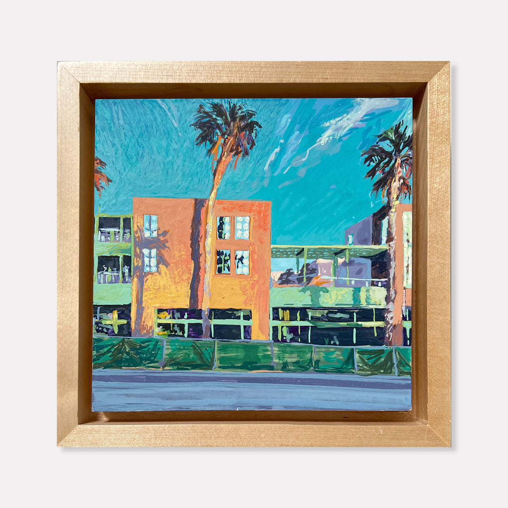 The artwork 'Coming Soon' by Justin Shull depicts a vibrant coastal scene with colorful art deco buildings in coral and yellow tones, tall palm trees casting shadows against a brilliant turquoise sky, and a seafront promenade with green railings. Painted in acrylic gouache on a 6x6 inch cradled panel with a gold frame, showcasing a modern impressionistic style. By Justin Shull.