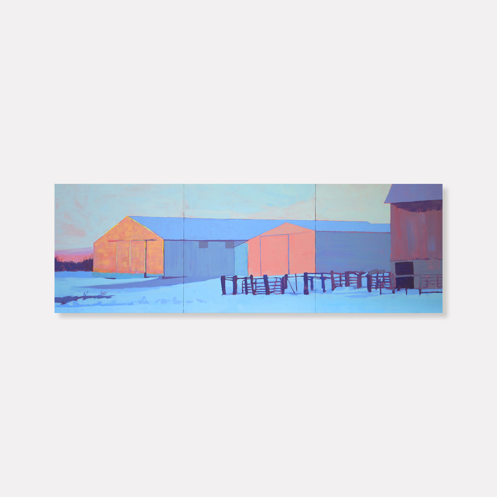 The artwork 'Three Barns' by Justin Shull depicts rustic farm buildings in a minimalist winter landscape. Coral-pink barns stand against a powder blue sky and snowy ground, with wooden fencing creating linear patterns across the composition. Painted in acrylic gouache with a contemporary geometric style that emphasizes bold shapes and serene color contrasts.