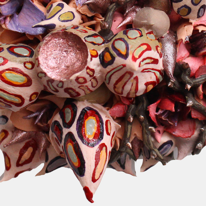 The artwork 'Pandora' by Seren Morey features intricate spherical forms adorned with vibrant leopard-like patterns in red, orange, and purple against pale pink surfaces. The ultralight acrylic creates a textured, biomorphic composition with raised elements and organic patterns, measuring 6.5 x 6.5 inches on panel.