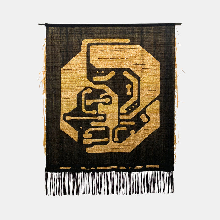 The artwork 'Personal Energetic Core' by Robin Kang features a striking circuit board-inspired design in metallic gold against a rich black background. Hand-woven using jacquard cotton and golden metallic yarns, the geometric pattern suggests technological circuitry with flowing lines and angular shapes, finished with delicate raffia fringe at the bottom.