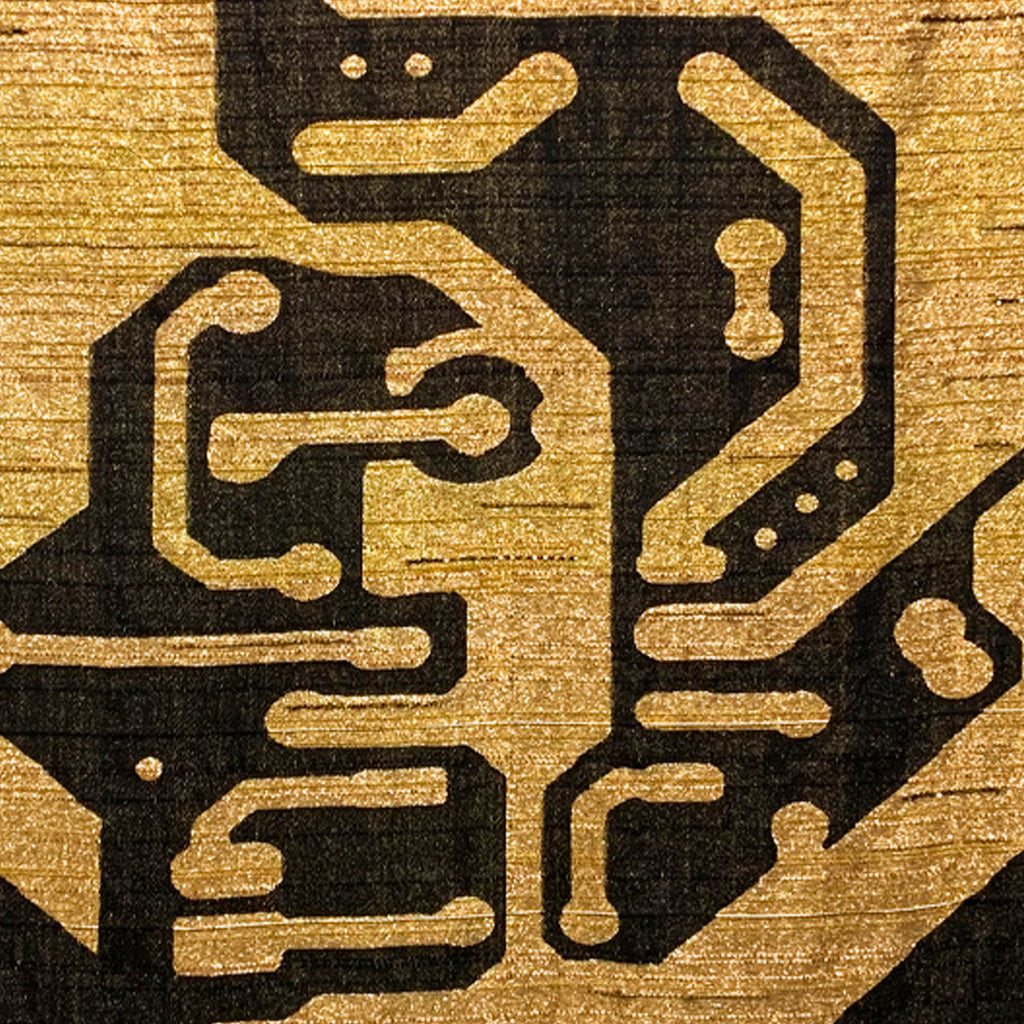 The artwork 'Personal Energetic Core' by Robin Kang features intricate circuit board-inspired patterns woven in black against a luminous golden background. Hand-jacquard weaving technique combines metallic yarns and cotton, creating bold geometric lines and paths resembling electronic circuitry, with subtle textural contrasts between smooth and raised surfaces.