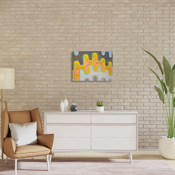 The artwork 'Radiance' by Jade Chan features vibrant undulating waves in yellow, orange, and light blue, creating a playful dripping effect against a neutral gray background. The abstract composition showcases flowing organic forms with smooth color transitions, painted in oil on canvas with a modern, contemporary style measuring 20x27 inches.