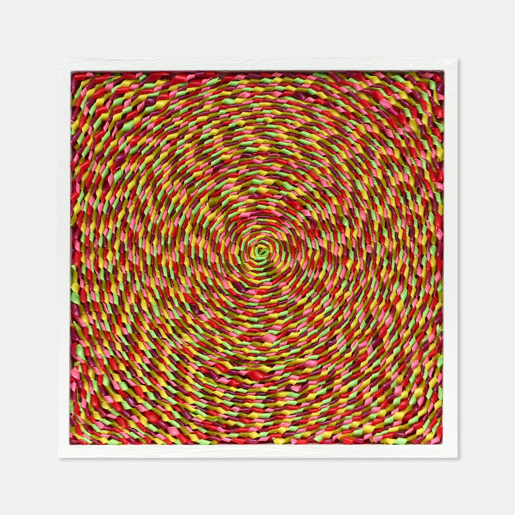 The artwork 'Raspberry Taffy' by Lori Kirkbride features a mesmerizing spiral pattern in vibrant red, yellow, and green hues. The circular composition radiates from a central point, creating a dynamic swirling effect. The acrylic and resin on panel technique creates a glossy, candy-like texture that emphasizes the piece's namesake confectionery appearance.