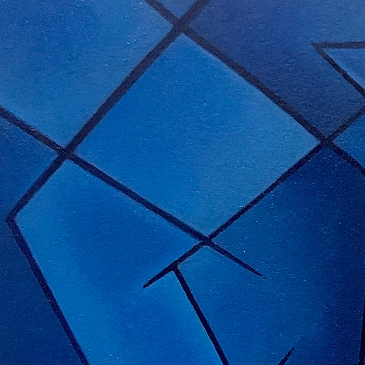 The artwork 'Ratcheted Rumination' by Joe Piscopia features abstract geometric shapes against a deep cobalt blue background. Sharp black lines intersect to create angular fragments, reminiscent of shattered glass. The oil painting on arches paper demonstrates a striking contrast between smooth blue surfaces and precise linear elements.
