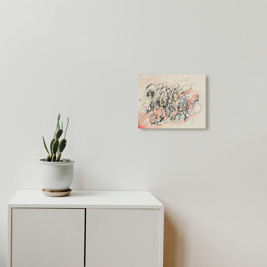 The artwork 'Red Wash' by Megan Olson features dynamic black calligraphic swirls and gestural marks flowing across white paper, accented with subtle coral pink washes. The abstract watercolor and gouache composition creates a sense of movement and energy, displayed above a minimalist white cabinet with a potted cactus. Art by Megan Olson.